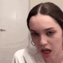 a woman is making a funny face with her mouth open .