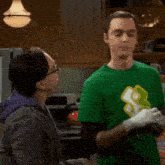 a man in a green shirt is laughing with a woman in a purple jacket