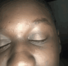 a close up of a person 's face with their eyes closed and their eyebrows visible .