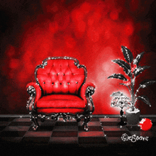 a red chair is sitting in front of a red wall and a potted plant