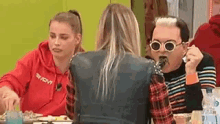 a man and a woman are sitting at a table eating food together .