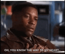 a man in a brown jacket is talking to another man .