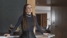 a woman leaning on a counter with her hands on it