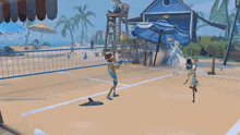 a couple of people playing volleyball on the beach