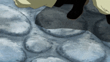 a close up of a person 's feet standing on a rocky surface