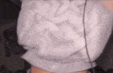 a close up of a person 's torso wearing a white shirt and headphones .
