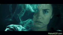 a close up of a woman 's face with smoke coming out of her eyes