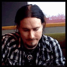 tuomas holopainen nightwish metal musician wiggle eyebrows plaid shirt