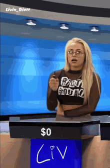 a woman stands behind a podium with a sign that says liv on it