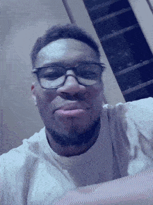 a man wearing glasses and a white shirt