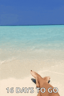 a person is laying on a beach with the words 16 days to go