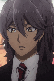a close up of a person with long hair wearing a suit
