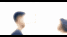 a man and a woman are looking at each other with their eyes closed