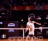 two men are playing tennis in front of a large engie sign