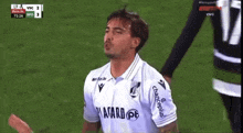 a soccer player wearing a white jersey that says asard