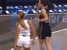 two female basketball players one of whom is wearing a skellion jersey