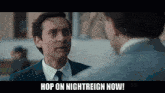 a man in a suit and tie talking to another man with the words hop on nightreign now written below him
