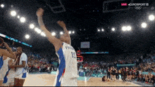 a basketball player with the number 15 on his jersey throws the ball