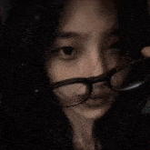 a close up of a woman wearing glasses and a nose ring