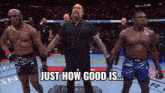 a referee stands between two fighters with the words just how good is behind him