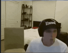 a man wearing headphones and a hat that says elwood on it