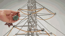 a person is holding a green ball in front of a tower