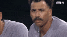 a man with a mustache is sweating while wearing a shirt that says yes
