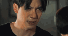 a close up of a man 's face with tears coming out of his eyes .