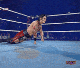 a wrestler in a wrestling ring with inlw written on the bottom right