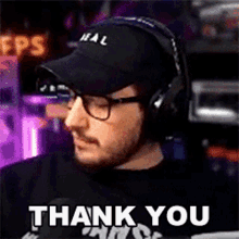 a man wearing headphones and a hat says thank you .