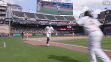a baseball game is being played in a stadium with a pizza hut ad on the outfield wall