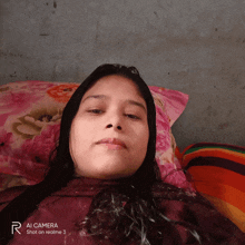 a woman laying on a bed with a pillow that says ai camera shot on realme 3 on it