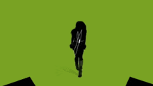 a silhouette of a woman wearing headphones dancing
