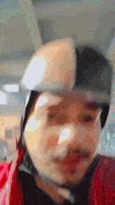 a man wearing a helmet and goggles is looking at the camera