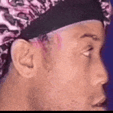 a close up of a man 's face with a bandana on