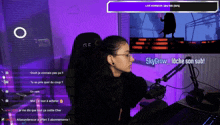 a woman is sitting in front of a microphone with the words skygrow_loche son sub