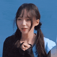 a girl with pigtails is wearing a blue sash with the letter y on it .