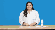 a woman in a lab coat is holding a bottle of glue in front of a blue background that says " happy friday "