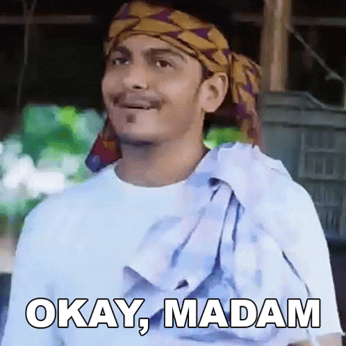 a man wearing a head scarf and a white shirt is saying okay madam