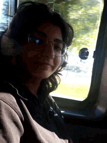 a woman wearing glasses and a shirt that says ' i love you ' on it