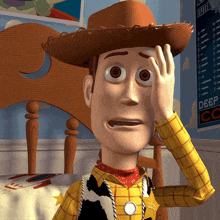 a toy story character covering his face with his hand