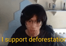 a man wearing headphones and glasses says `` i support deforestation '' while looking at the camera .