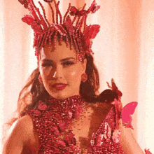 a woman wearing a red dress and a crown of butterflies