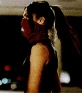 a woman is wearing a red scarf around her face