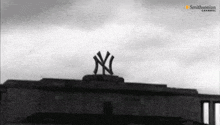 a black and white photo of a new york yankees logo on the top of a building .