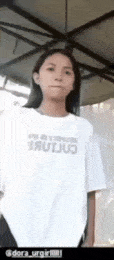 a woman wearing a white t-shirt with the word brutus on it .