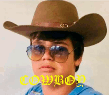 a young boy wearing a cowboy hat and sunglasses with the word cowboy written in yellow