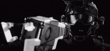 a black and white photo of a person wearing a helmet and goggles