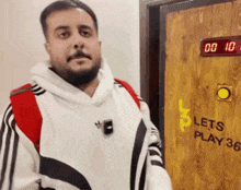 a man standing in front of a door that says lets play 3