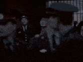 a blurry photo of a group of people including a man wearing a hat